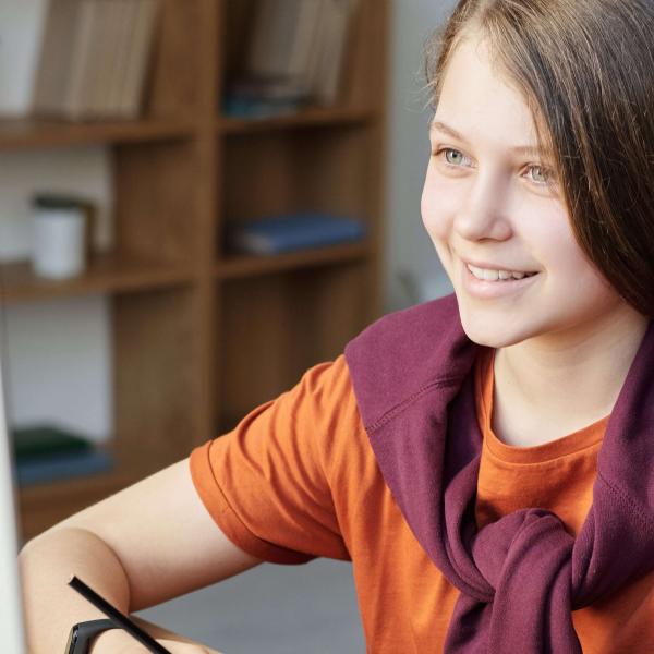 A middle school student engages in classwork at a computer