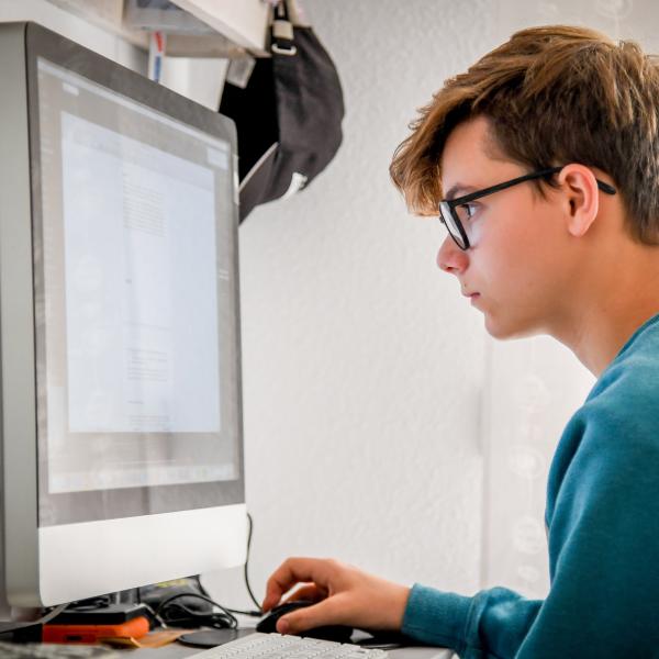 high school cyber security student working on computer