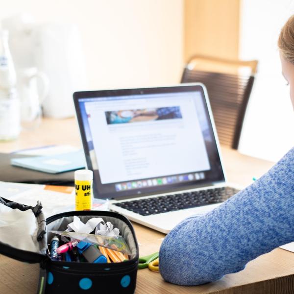 teenage middle schooler doing schooling on a laptop