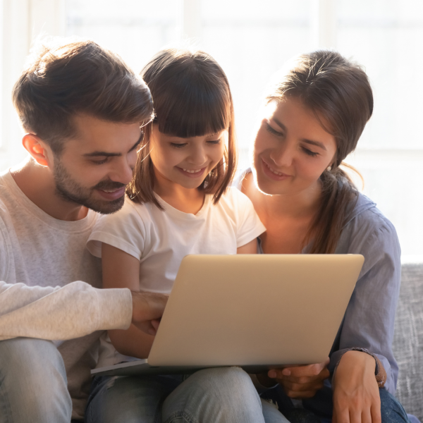 Smiling family looking at computer