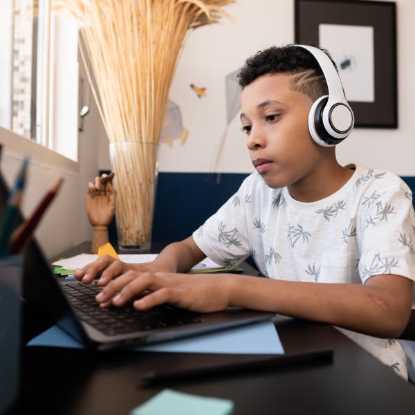 Male student studying at home desk