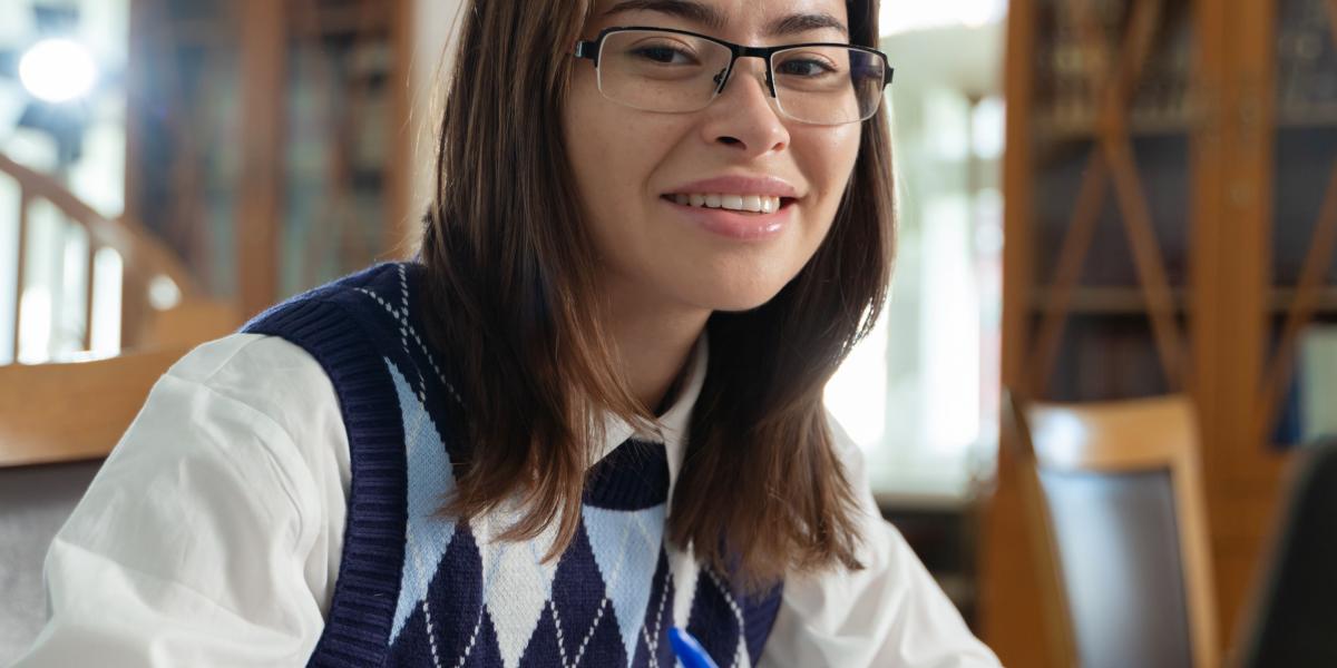 Student working on a laptop in her home